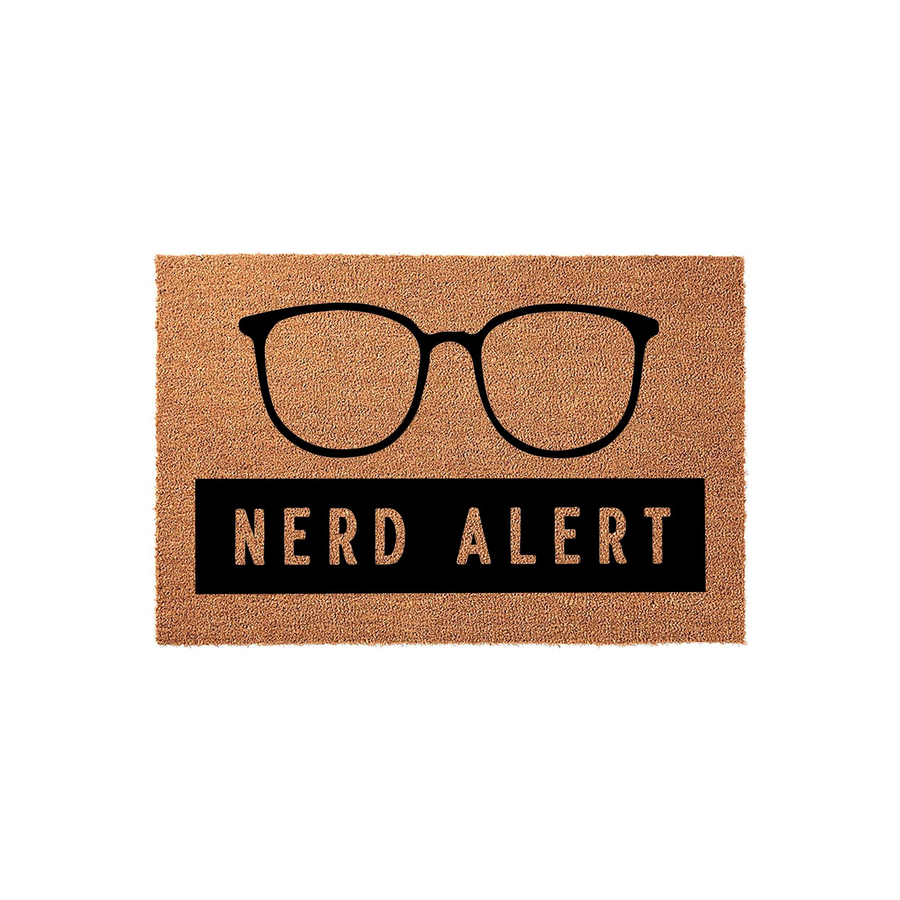 Nerd Alert coir doormat featuring a bold black graphic of oversized glasses above the text, set against a natural brown fiber background that adds a fun and welcoming touch to any front porch or entryway for fans of geeky home