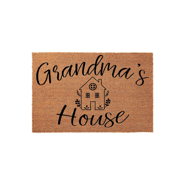 Grandma's House coir doormat featuring a natural tan fiber texture with black printed text and a charming line-art illustration of a small cottage home, creating a welcoming entryway accent for a grandparent's front porch decor.