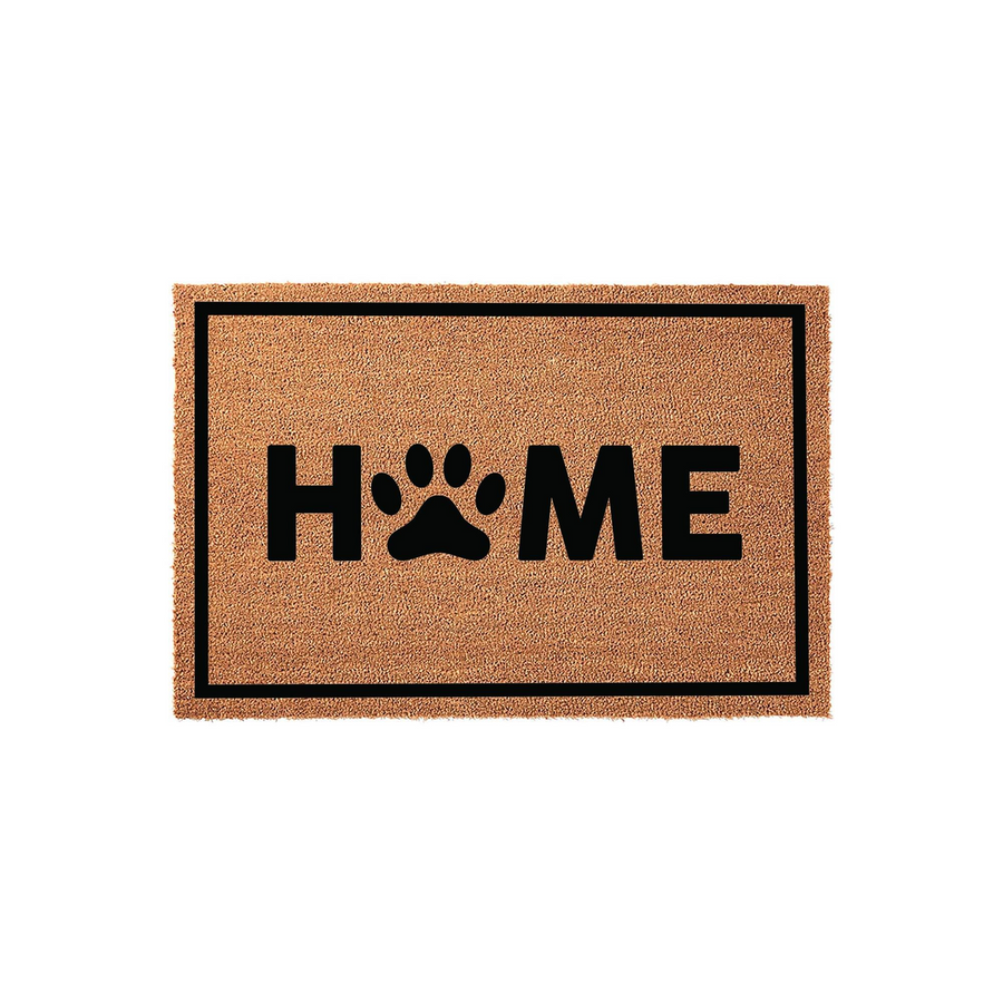 Paw Print Home Coir Doormat featuring a natural tan fiber texture with a black border and the word HOME printed in bold black letters, where the letter O is replaced by a cute dog paw print for a pet lover entryway decor style.