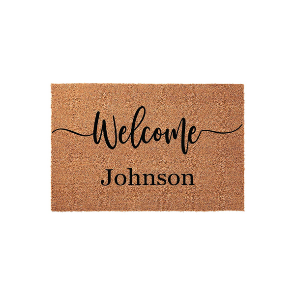 Personalized coir welcome doormat featuring the word Welcome in elegant black script lettering above a customizable family name, set against a natural brown textured fiber background for a classic front porch entryway decor.