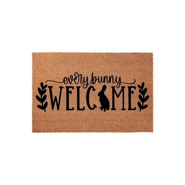 Every Bunny Welcome coir doormat featuring a cute rabbit silhouette integrated into the text design, accented by black leafy branches on a natural brown fiber background for a festive spring or Easter home entryway decor piece.