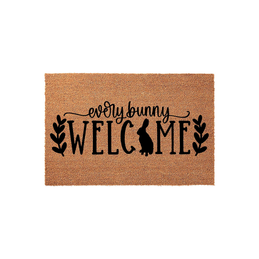 Every Bunny Welcome coir doormat featuring a cute rabbit silhouette integrated into the text design, accented by black leafy branches on a natural brown fiber background for a festive spring or Easter home entryway decor piece.