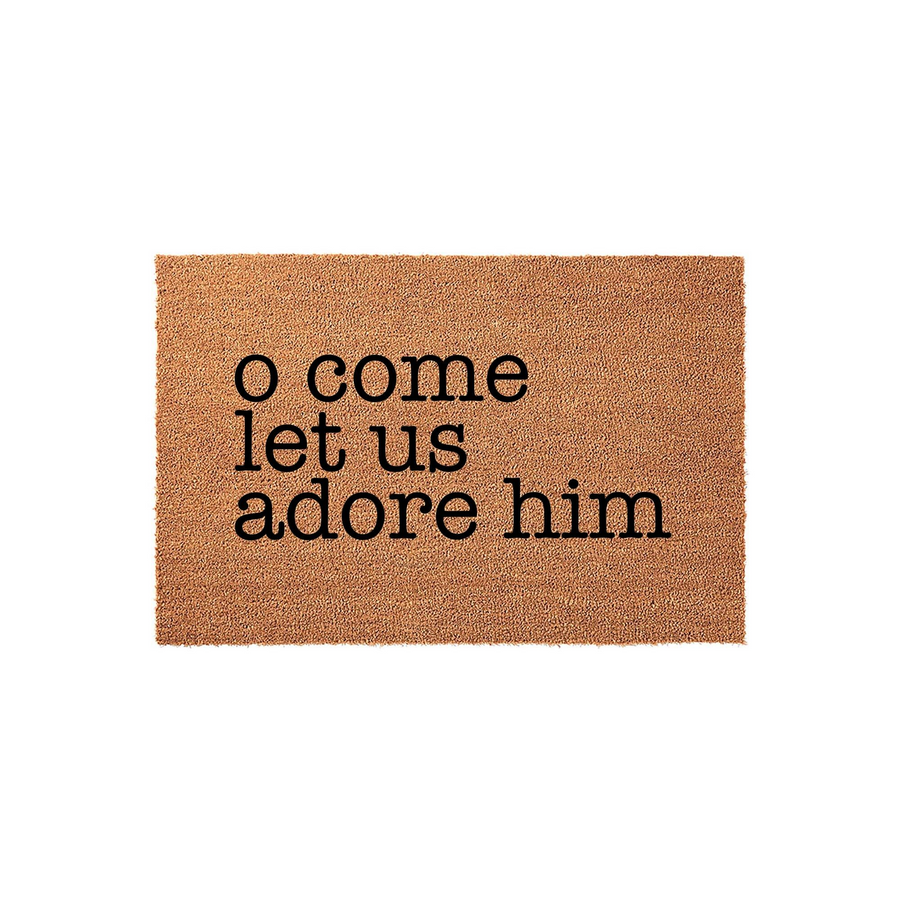 O Come Let Us Adore Him Christmas doormat featuring natural coir fibers and bold black lettering, providing a festive and welcoming holiday entrance for your front porch decor during the winter season on a clean white background.