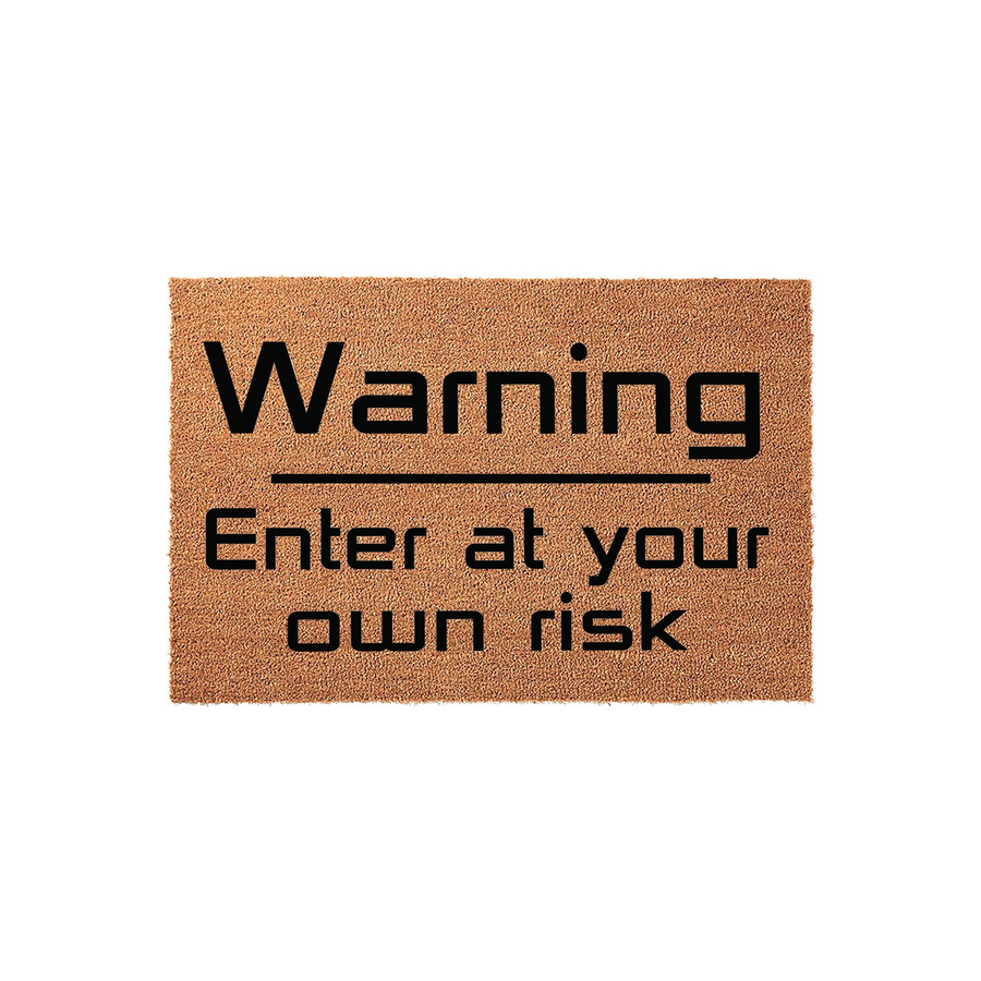 Warning Enter at your own risk coir doormat featuring bold black text printed on a natural brown fiber background, creating a humorous and functional front porch welcome mat for any home entrance that needs a bit of personality.