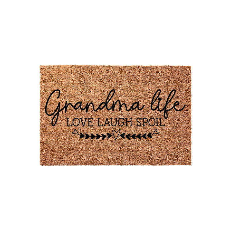 Grandma Life coir doormat featuring a natural tan fiber texture with black printed text that reads Love Laugh Spoil, accented by a decorative heart and arrow design on a clean, isolated white background for a welcoming home