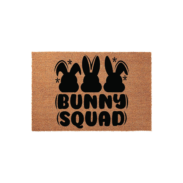 Bunny Squad Easter coir doormat featuring three black rabbit silhouettes and playful retro-style typography on a natural tan fiber background, making a festive spring welcome mat for your front porch or entryway decor.