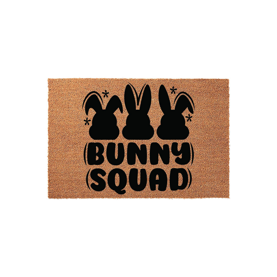 Bunny Squad Easter coir doormat featuring three black rabbit silhouettes and playful retro-style typography on a natural tan fiber background, making a festive spring welcome mat for your front porch or entryway decor.