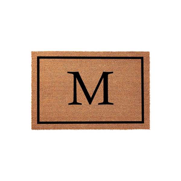 Personalized monogram coir doormat featuring a large black letter M centered within a simple rectangular border, set against a clean white background to showcase the natural tan texture of the durable outdoor welcome mat material.