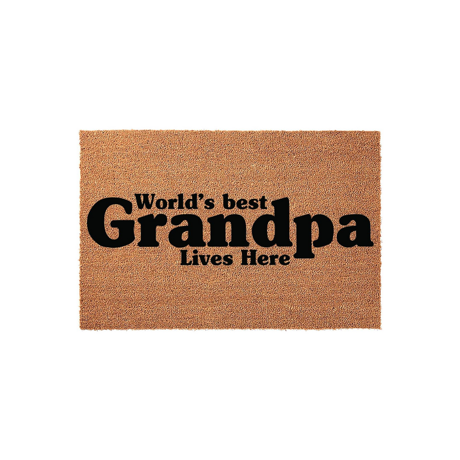 World's Best Grandpa Lives Here coir doormat featuring bold black typography printed on a natural tan fiber background, creating a welcoming and durable entrance mat for a home that celebrates a beloved grandfather.