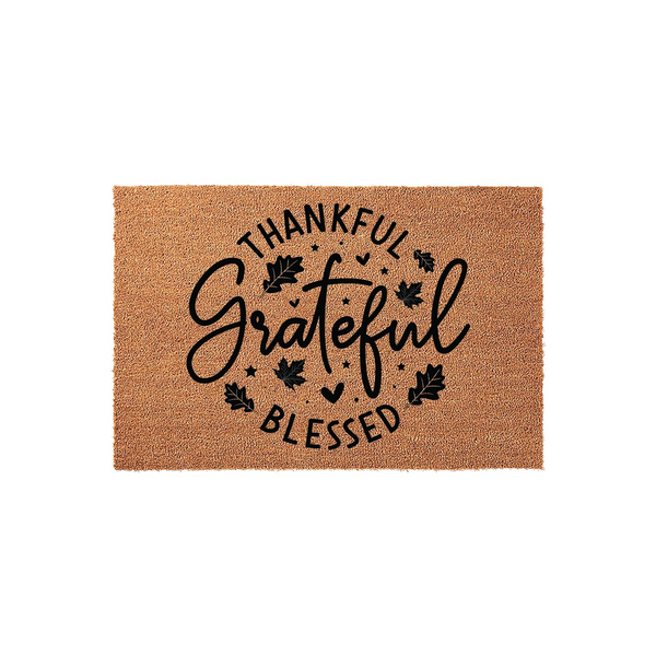 Thankful Grateful Blessed coir doormat featuring a natural tan fiber texture with black printed text and autumn leaf accents, creating a festive fall entryway decor piece for your front porch or home entrance during the harvest