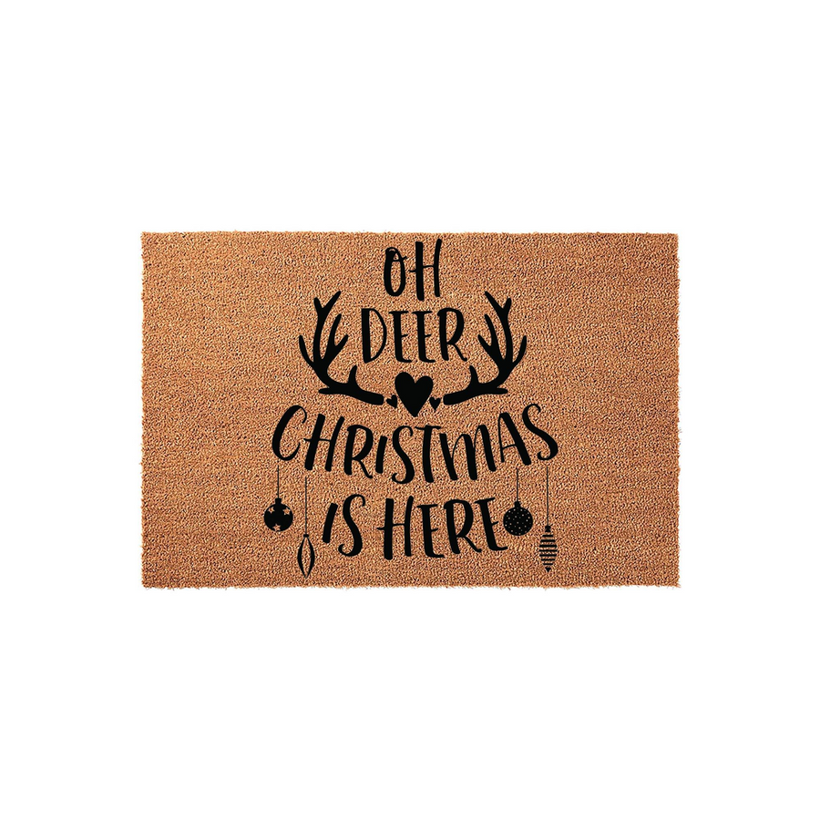 Oh Deer Christmas Is Here coir doormat featuring black text and a deer antler graphic with hanging ornaments, designed to add a festive holiday touch to your front porch entryway during the winter season on a natural fiber mat.