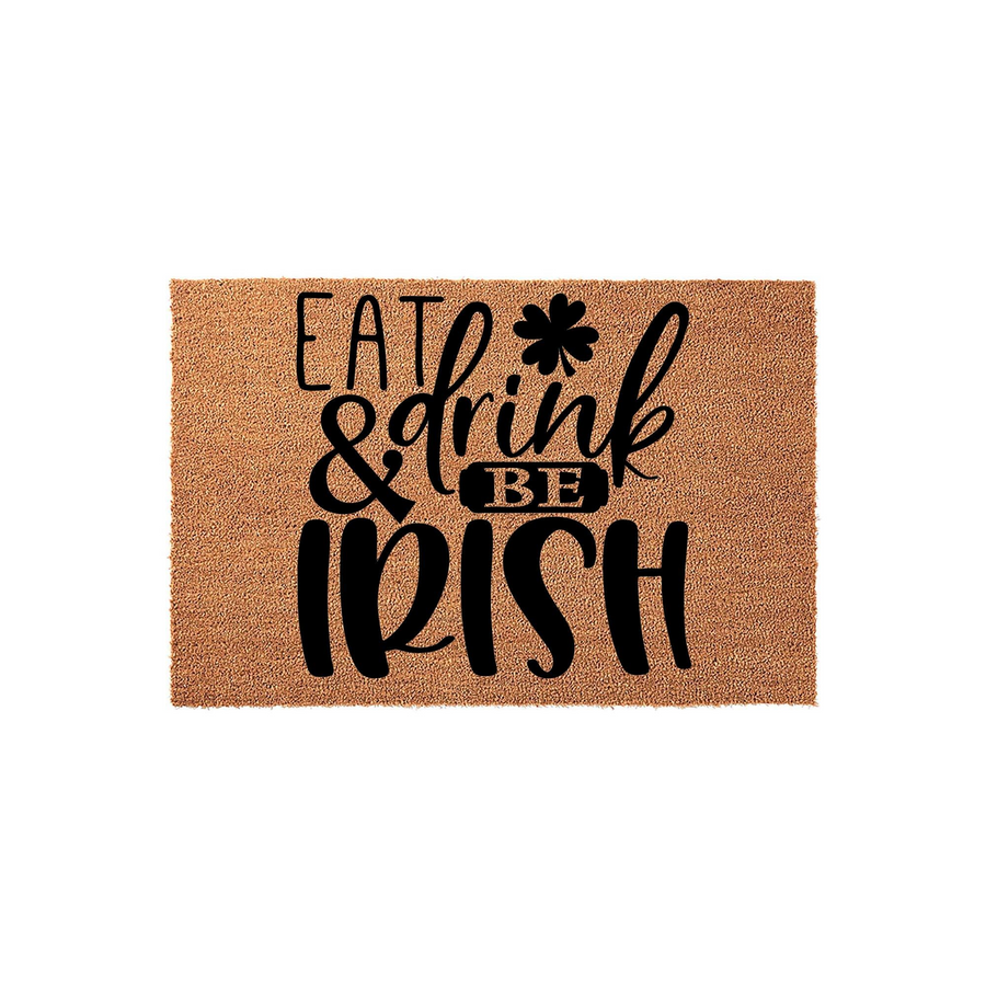 Eat and Drink Be Irish St. Patrick's Day coir doormat featuring bold black typography and a shamrock icon on a natural tan fiber background, creating a festive entryway decor piece for your home during the spring holiday season.