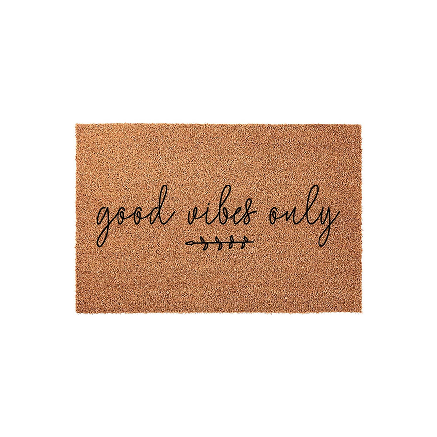 Good Vibes Only coir doormat featuring a natural brown fiber texture and black cursive lettering, centered with a small decorative leaf branch design on a clean white background for a modern entryway decor aesthetic.