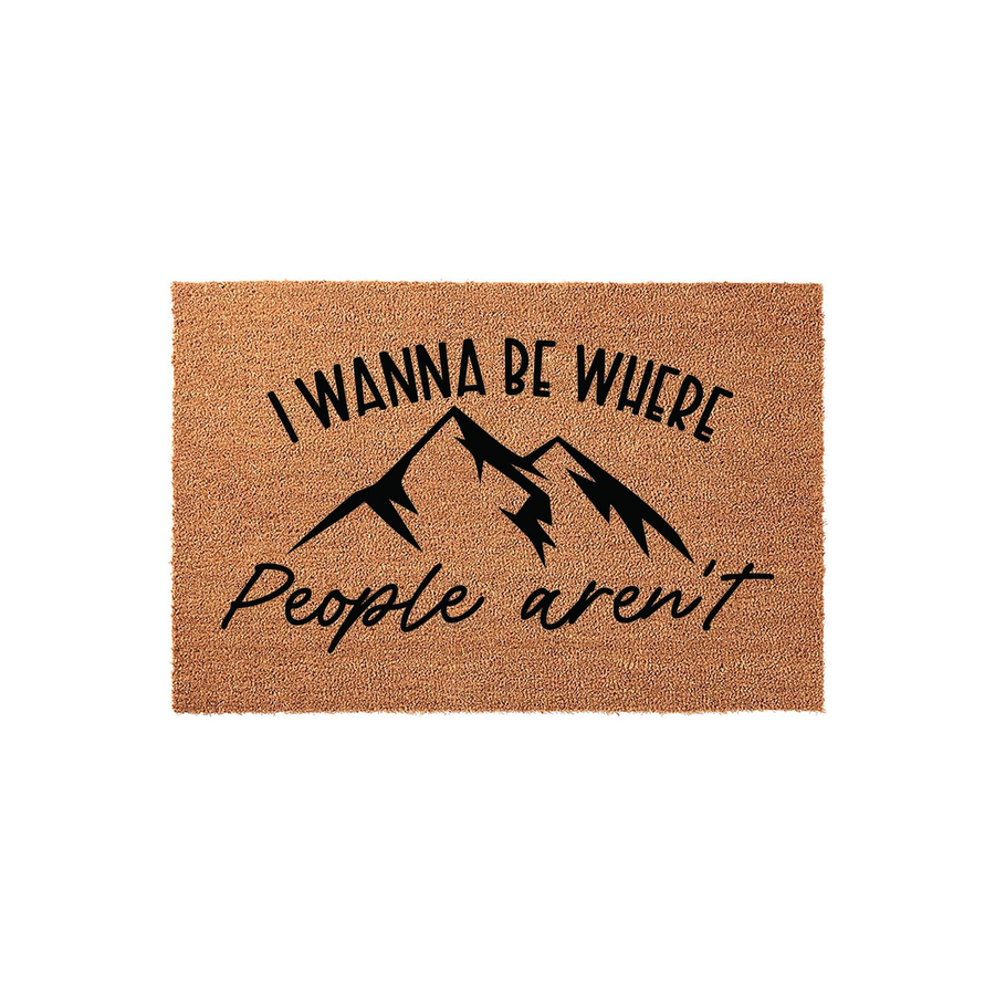 Mountain Theme Coir Doormat featuring a natural brown fiber texture and black printed text that reads I Wanna Be Where People Aren't, centered around a bold mountain range graphic for a rustic outdoor entrance or cabin home decor.