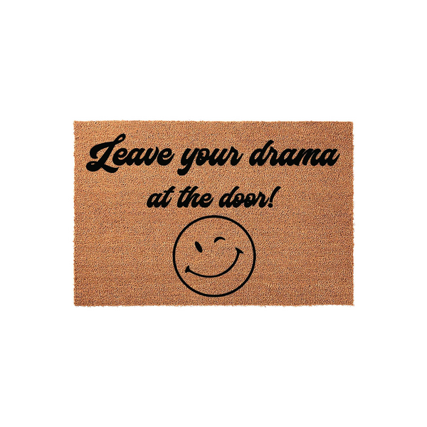 Leave Your Drama At The Door doormat made of natural coir fibers, featuring bold black text and a winking smiley face icon centered on the mat, presented against a clean white background for a modern and humorous home entryway