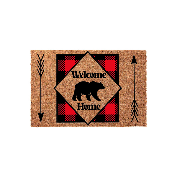 Rustic Bear Welcome Home Doormat featuring a black bear silhouette centered on a red and black buffalo plaid diamond pattern, accented by decorative arrows on a natural coir fiber background for a cozy cabin entryway decor style.
