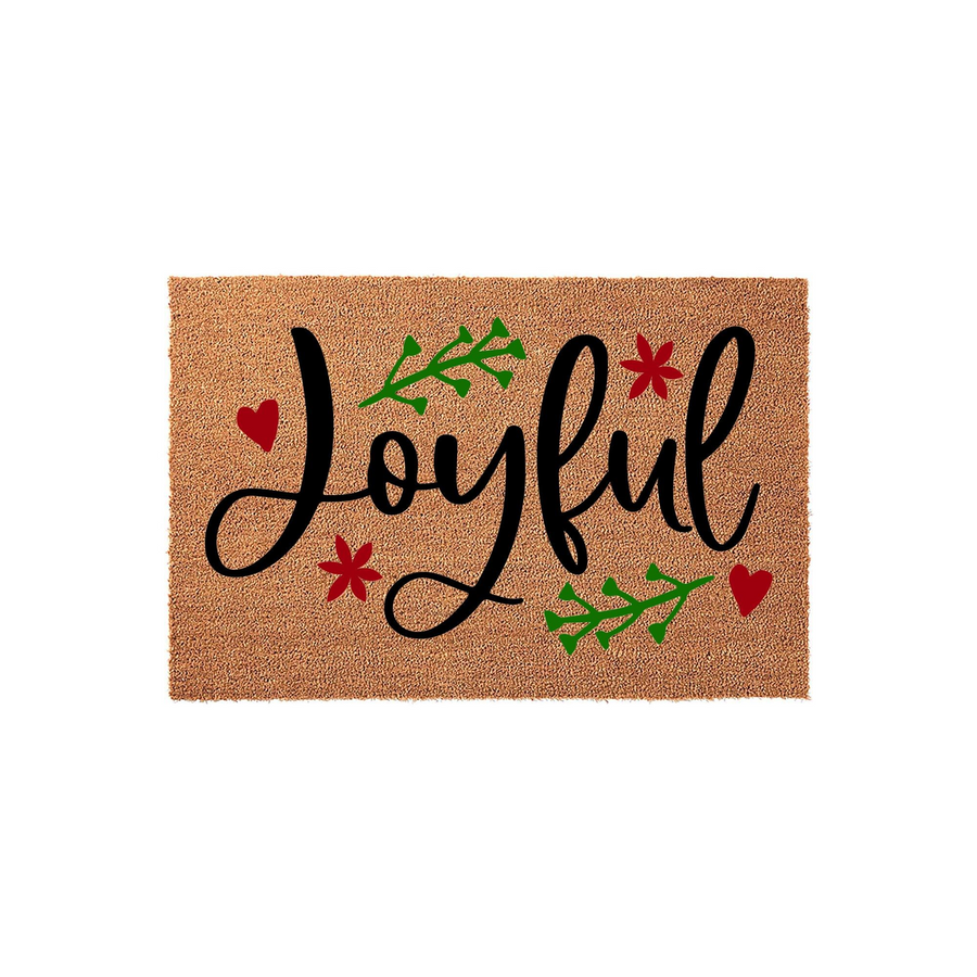 Joyful Christmas doormat made of natural coir fiber, featuring elegant black cursive lettering accented with festive green sprigs, red hearts, and small star-shaped flowers for a cheerful holiday entryway decor style.