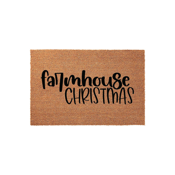Farmhouse Christmas doormat made of natural coir fiber with a rectangular shape, featuring bold black script lettering that reads Farmhouse Christmas centered on the textured brown surface for a festive holiday entryway decor.