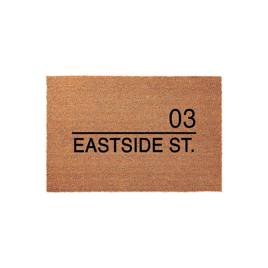 Personalized address coir doormat featuring a natural tan fiber texture with bold black text that displays a house number and street name, providing a durable and welcoming entrance mat for any front porch or home entryway.