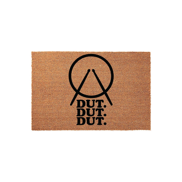 Drummer Coir Doormat featuring a black graphic of crossed drumsticks inside a circle with the text DUT DUT DUT printed below, set against a natural tan textured coir background for a fun musical entrance to any home or music