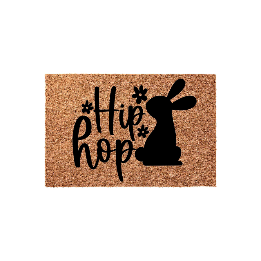 Easter Bunny Hip Hop Doormat featuring a natural coir texture with a bold black silhouette of a rabbit and decorative floral accents, creating a festive spring entryway decor piece for your front porch or home entrance.