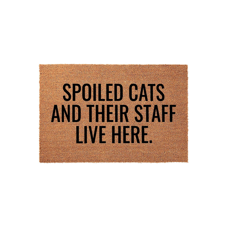 Spoiled Cats and Their Staff Live Here coir doormat featuring bold black text on a natural brown fiber background, making it a funny and welcoming entrance rug for any cat lover's home front porch or entryway decor.