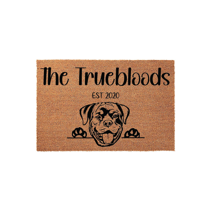 Personalized Rottweiler doormat featuring a cute dog illustration peeking over a line, customized with a family name and established year on a natural tan coir fiber background for a welcoming front porch entrance.