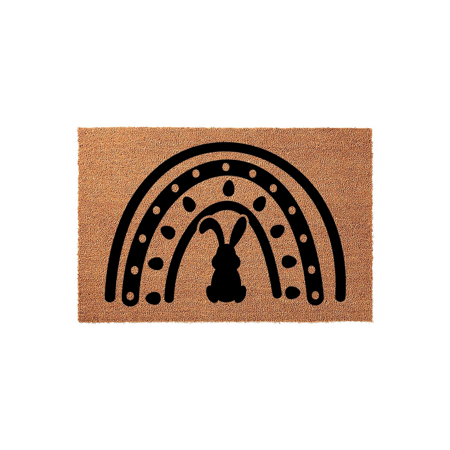 Easter Bunny Rainbow Coir Doormat featuring a natural brown fiber texture with a bold black graphic of a rabbit silhouette centered under a decorative rainbow arch, perfect for seasonal spring home decor on a front porch or