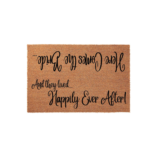 Wedding Welcome Doormat featuring natural coir fibers and black script text that reads Here Comes the Bride and And they lived Happily Ever After, designed as a charming entryway floor mat for a newlywed couple's home on a white