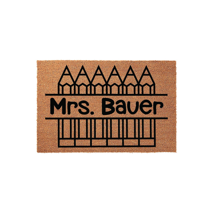 Personalized teacher doormat featuring a brown coir texture with a black graphic of pencils and a piano keyboard, displaying a custom name line for a classroom entrance on a clean white background for a professional school look.