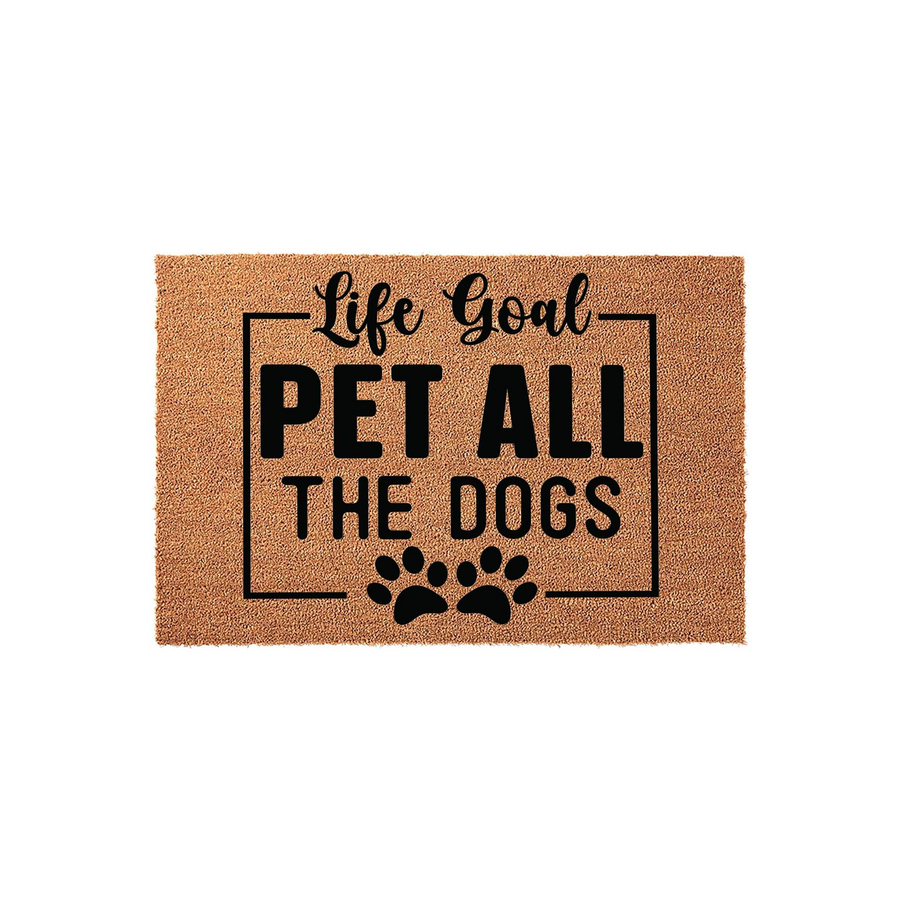 Life Goal Pet All The Dogs coir doormat featuring a natural brown fiber texture and bold black text inside a rectangular border, accented with two paw prints at the bottom for a fun and welcoming entrance for any dog lover home