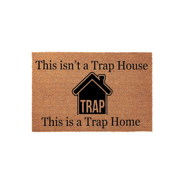 Funny Trap Home Doormat featuring a natural coir texture with black text that reads This isn't a Trap House, This is a Trap Home, centered around a bold house icon on a clean white background for a modern entryway decor statement.