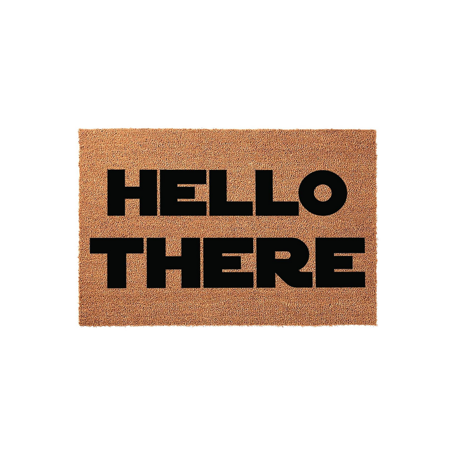 Hello There natural coir doormat featuring bold black lettering on a textured brown coconut fiber background, providing a welcoming and modern aesthetic for your front porch or entryway decor in a clean studio product shot.