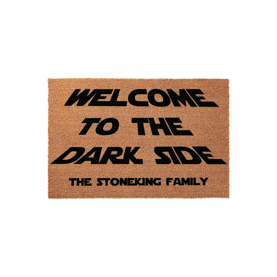 Personalized Star Wars themed doormat featuring the text Welcome to the Dark Side and a custom family name printed in bold black lettering on a natural brown coir fiber background, perfect for any sci-fi fan home entrance decor.