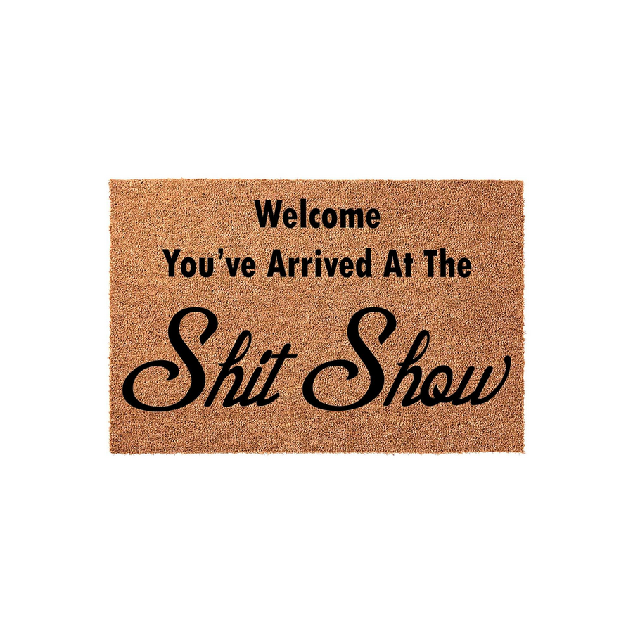 Funny Welcome Doormat featuring a natural coir texture with bold black text that reads Welcome You've Arrived At The Shit Show, making this humorous outdoor floor mat a cheeky addition to any front porch or entryway decor for