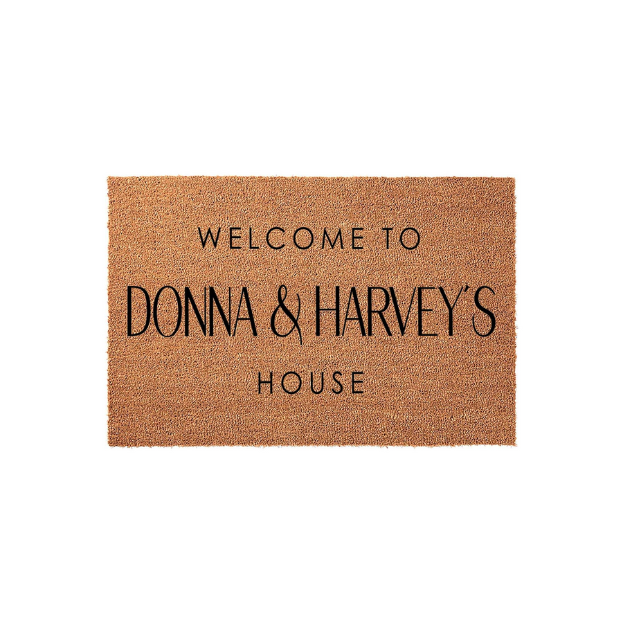Personalized coir welcome doormat featuring a natural tan fiber texture and bold black lettering that reads Welcome To and House, with space in the center for a custom family name to create a warm entrance for any home front