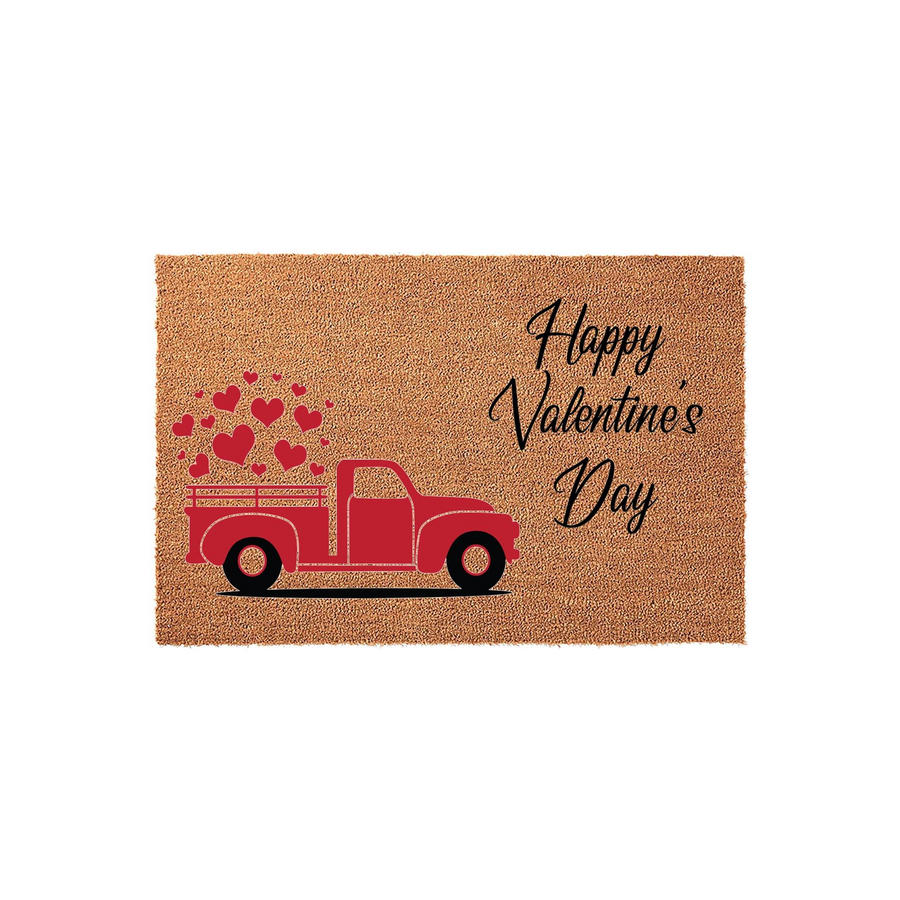 Happy Valentine's Day coir doormat featuring a red vintage truck carrying a load of floating red hearts, set against a natural tan fiber background to add a festive and welcoming touch to your front porch decor for the holiday