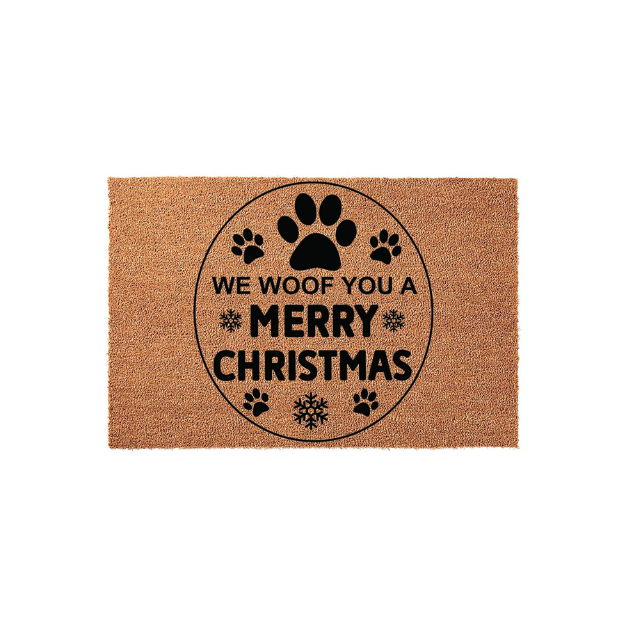 We Woof You A Merry Christmas coir doormat featuring a circular design with black paw prints and snowflakes, providing a festive and welcoming touch to your front porch decor during the holiday season for any dog lover's home