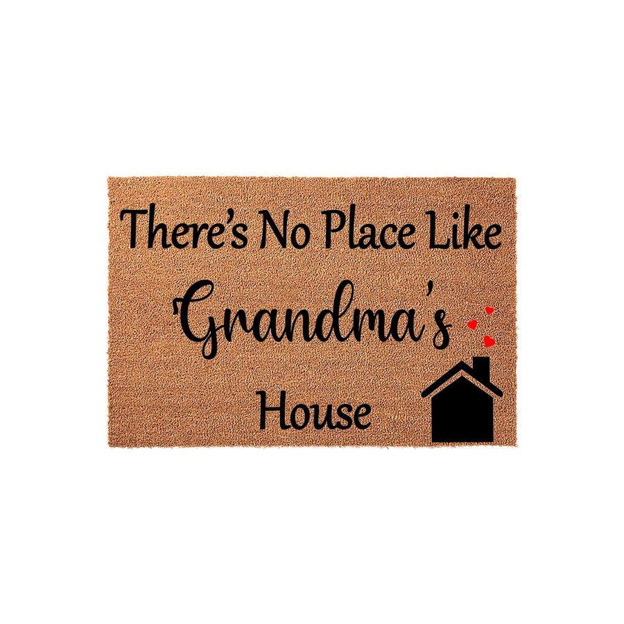 Grandma's House coir doormat featuring a natural tan fiber texture with black printed text that reads There's No Place Like Grandma's House, accented by a small black house icon and two tiny red hearts floating above the chimney.