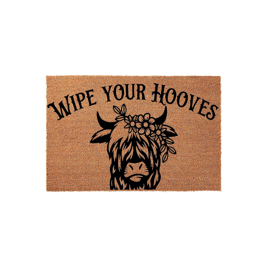 Highland Cow Wipe Your Hooves doormat featuring a natural coir texture with a black printed illustration of a shaggy Highland cow wearing a floral crown, centered on a plain white background for a rustic farmhouse entryway decor