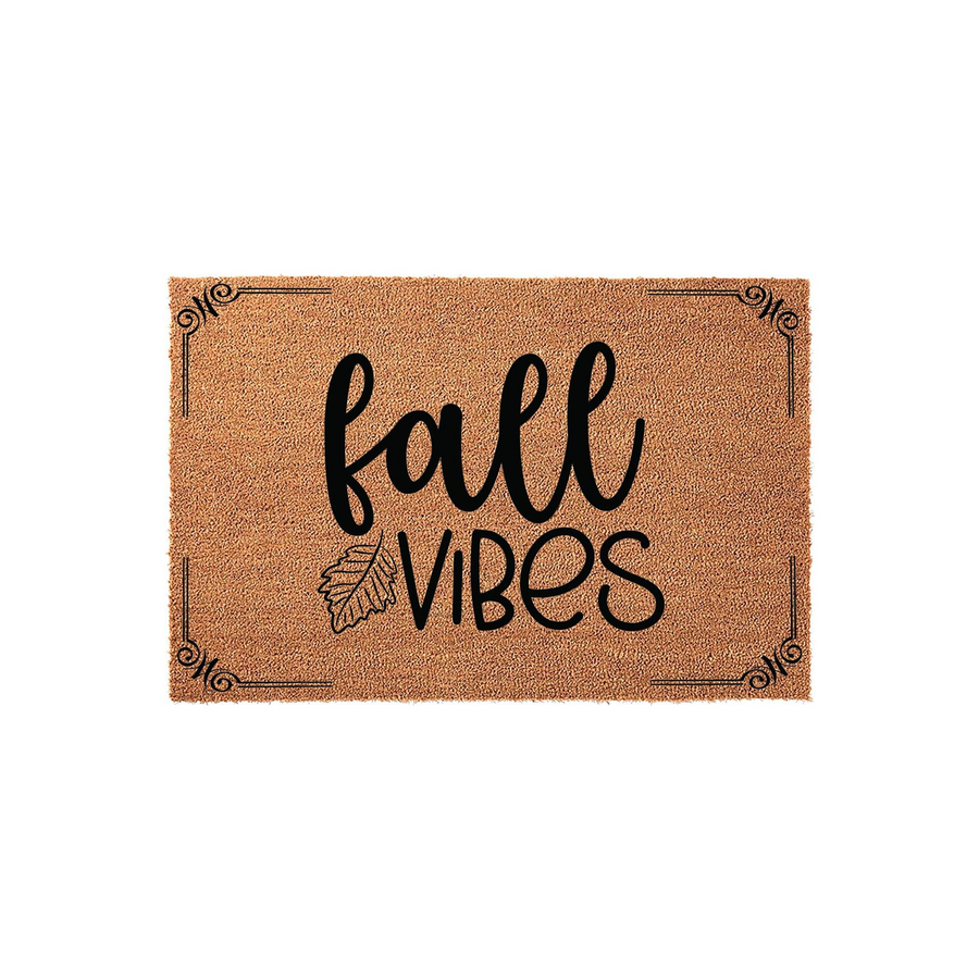 Fall Vibes coir doormat featuring a natural brown fiber texture with black printed text and a decorative leaf accent, framed by elegant corner flourishes on a clean white background for a seasonal front porch entryway decor