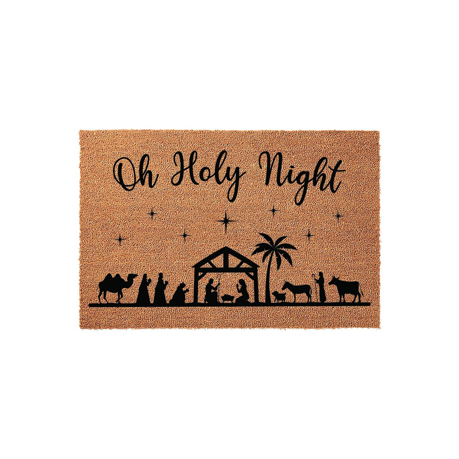 Oh Holy Night nativity doormat featuring a natural coir texture with a black silhouette design of the manger scene, palm tree, and stars, creating a festive religious welcome for your front porch during the Christmas holiday