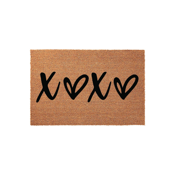 XOXO Coir Doormat featuring a natural brown fiber texture and bold black hand-lettered text that reads XOXO with heart shapes, creating a charming and welcoming entryway accent for your home decor on a clean white background.