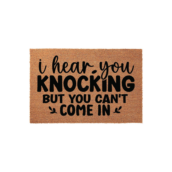 Funny I Hear You Knocking But You Can't Come In coir doormat featuring bold black typography on a natural brown fiber background, creating a humorous and welcoming entrance decor piece for your front porch or home entryway.