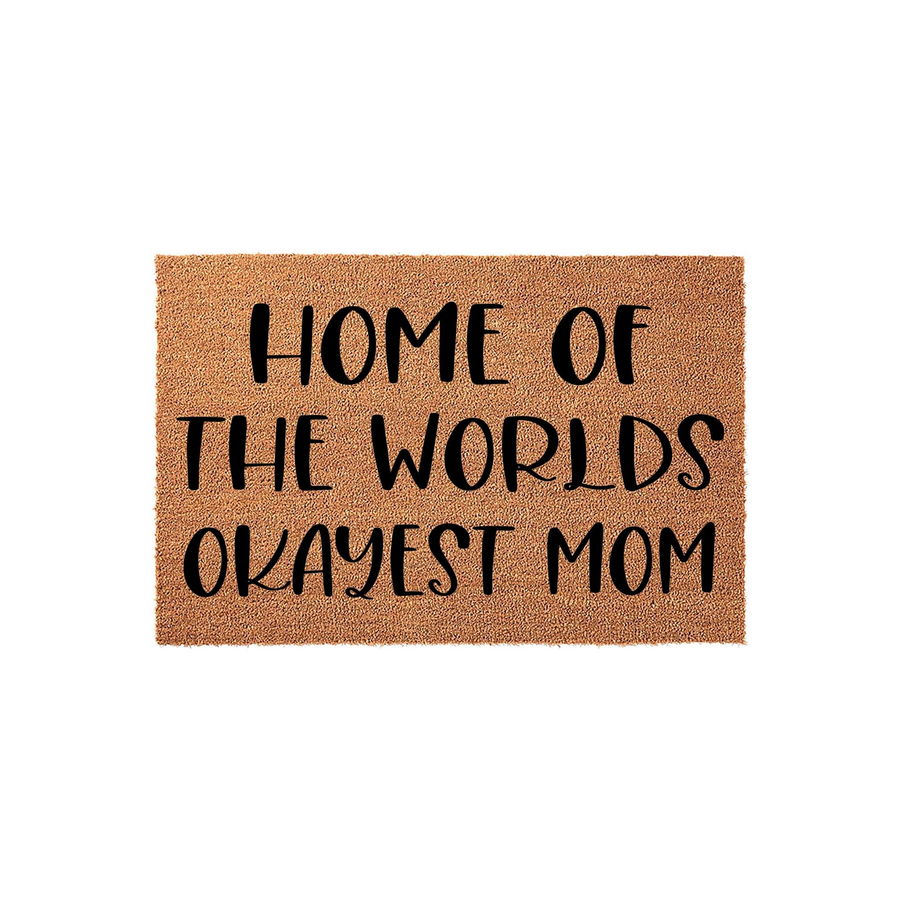 Funny Mom doormat featuring natural coir fibers and bold black text that reads Home of the Worlds Okayest Mom, providing a humorous and welcoming touch to any front porch or entryway for a lighthearted home decor style.