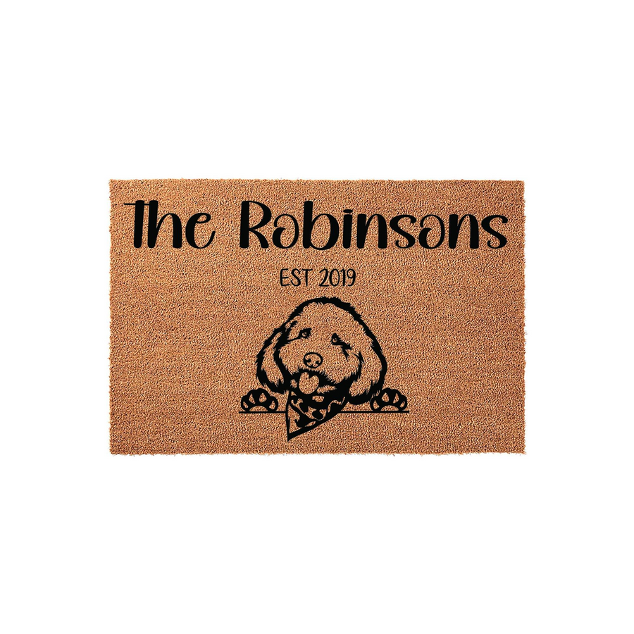 Personalized Goldendoodle family doormat featuring a cute illustrated dog wearing a bandana, customized with a family name and established year on a natural coir fiber background for a welcoming front porch entrance.