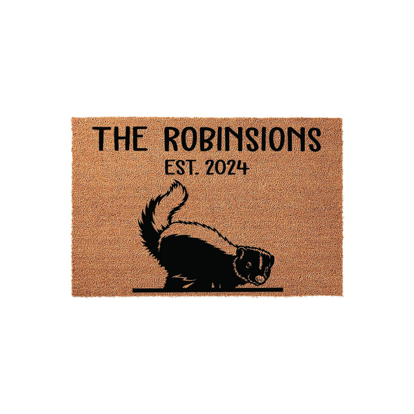 Personalized skunk family doormat featuring a cute black and white skunk illustration, custom family name text, and established year printed on a durable natural coir fiber mat against a clean white studio background.