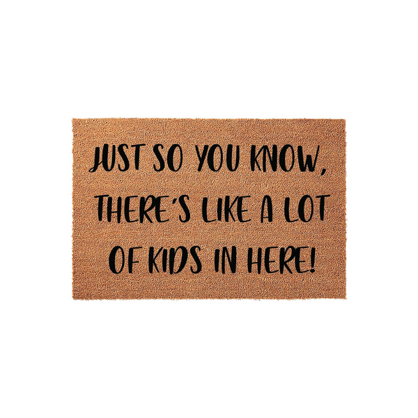 Funny Kids Welcome Doormat featuring a natural coir texture with bold black text that reads Just So You Know, There Is Like A Lot Of Kids In Here, making it a humorous and practical front porch decor piece for a busy family home