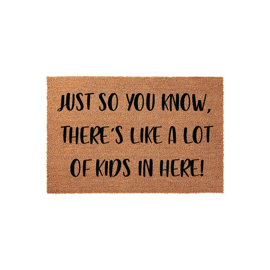 Funny Kids Welcome Doormat featuring a natural coir texture with bold black text that reads Just So You Know, There Is Like A Lot Of Kids In Here, making it a humorous and practical front porch decor piece for a busy family home