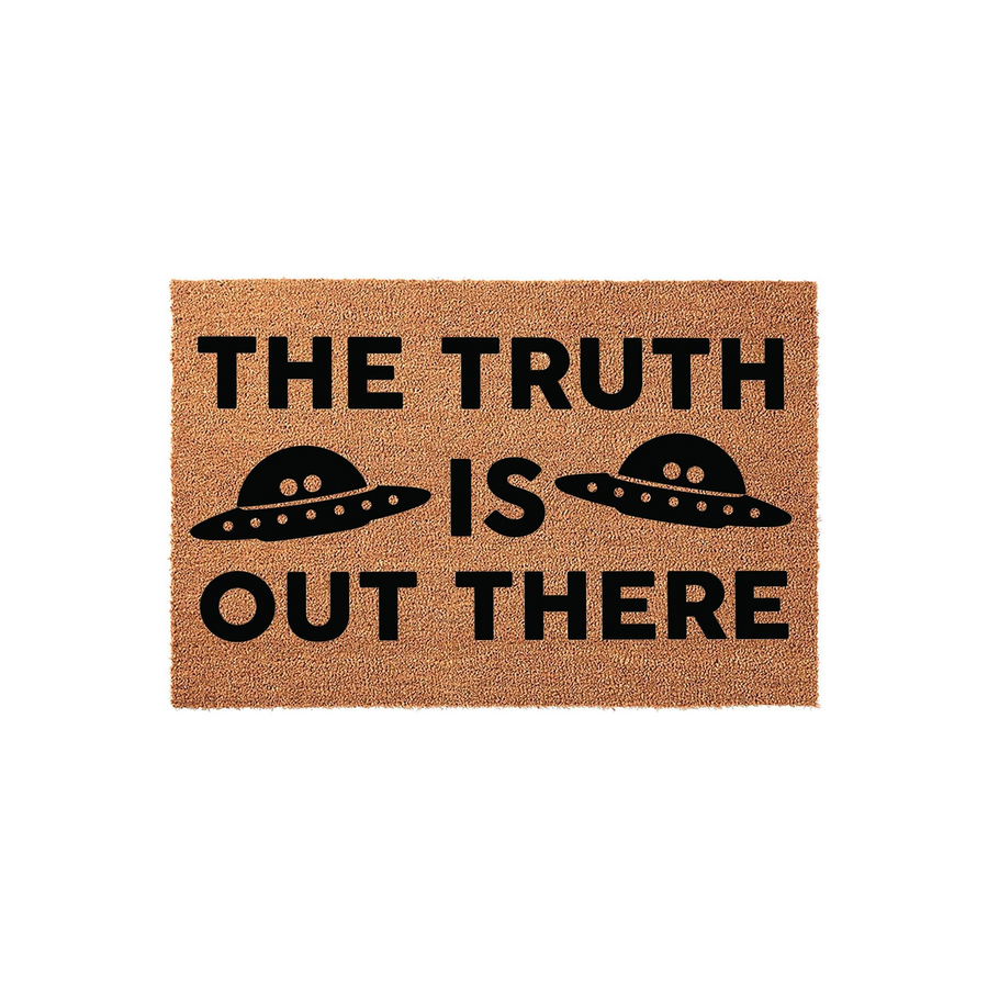 The Truth Is Out There UFO doormat featuring a natural coir fiber texture with bold black text and two flying saucer illustrations, making a fun sci-fi themed entrance rug for any home or apartment doorway that loves space and